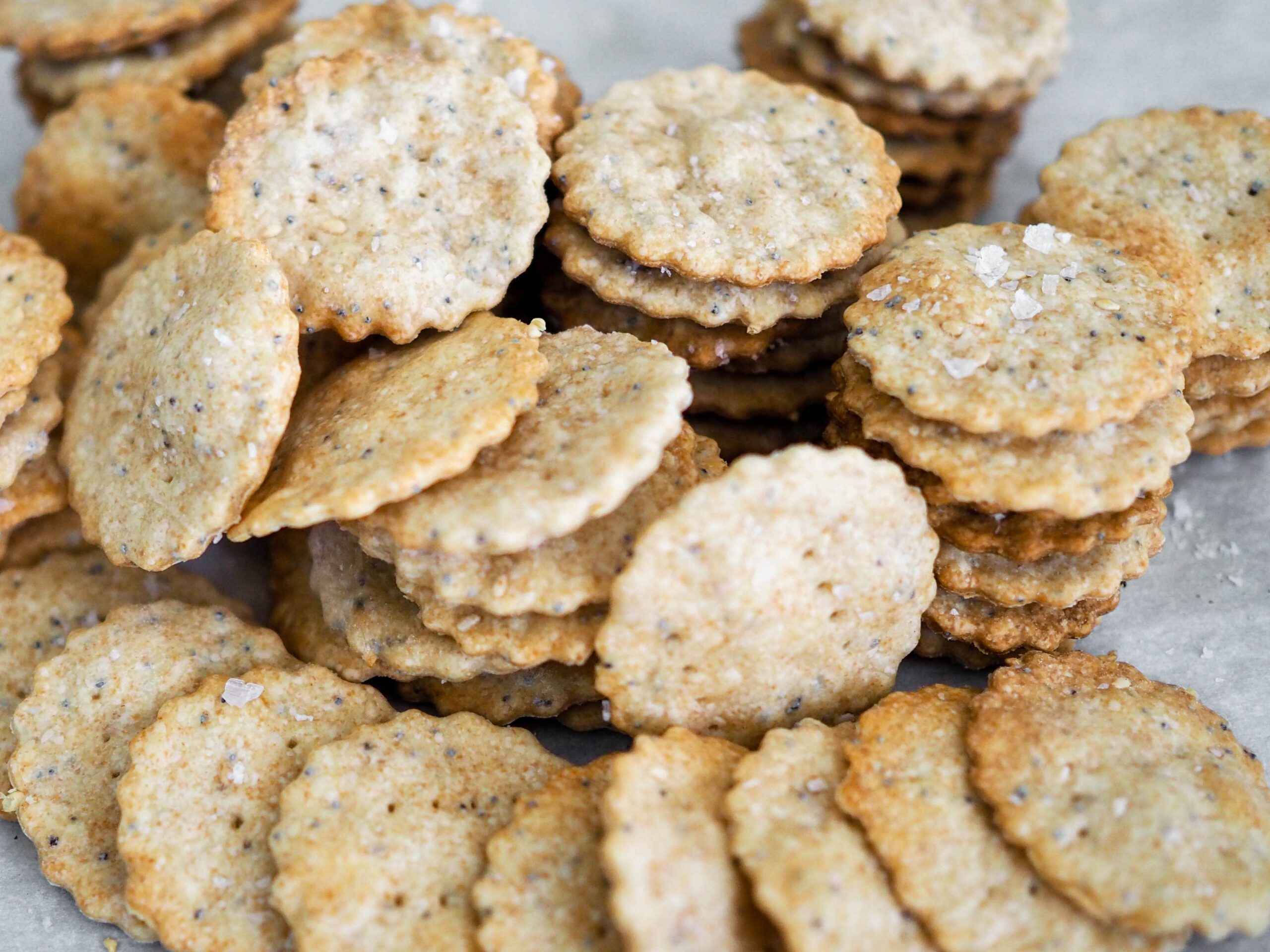 A stack of sesame and poppy seed crackers.