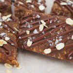Chocolate protein granola bars arranged on parchment paper