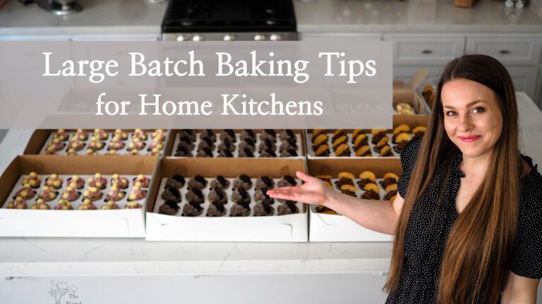 Alyssa stands proudly in front of 230 cupcakes, gesturing at them. An overlay reads, "large batch baking tips for home kitchens."