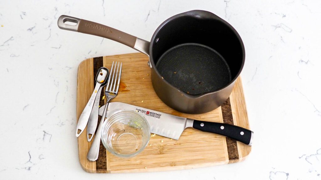 A collection of kitchen tools and items used to make the ramen.