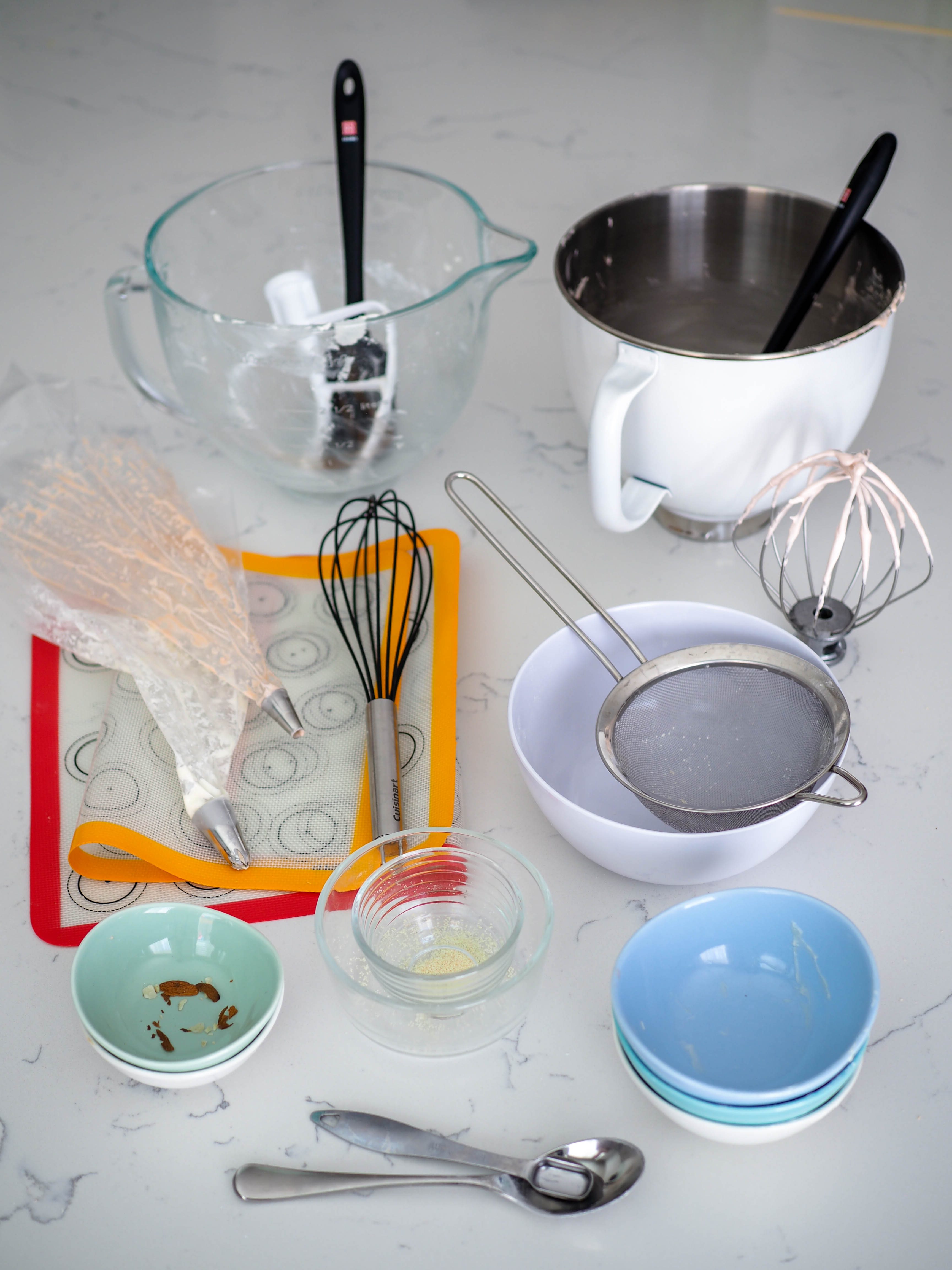 An assortment of dishes used in making almond macarons.