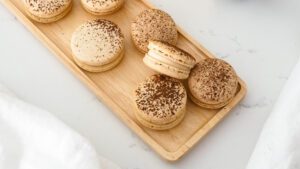 A platter of tiramisu macarons, with one angled to face the camera.