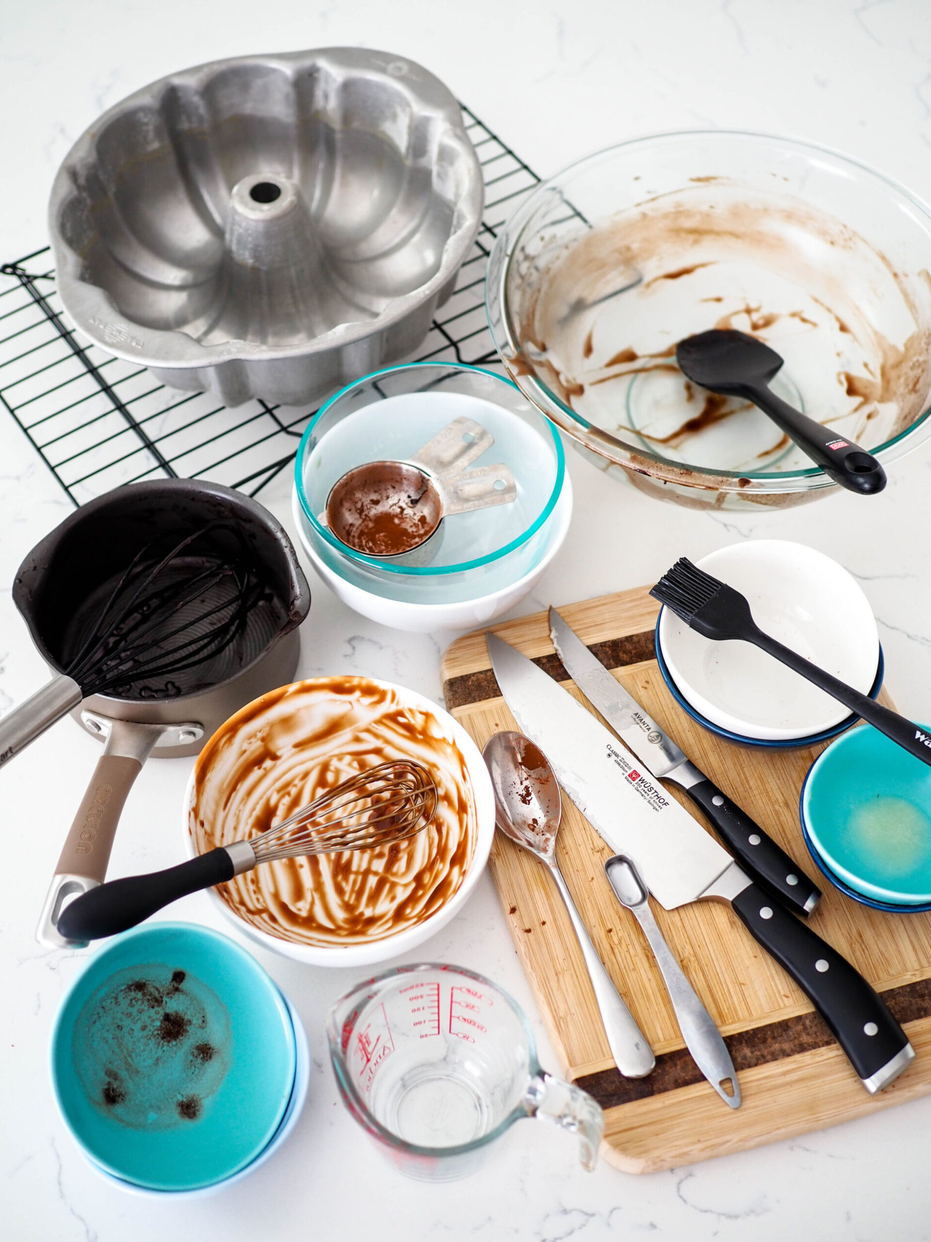 Dishes used to make the chocolate Bundt cake piled up on a counter.