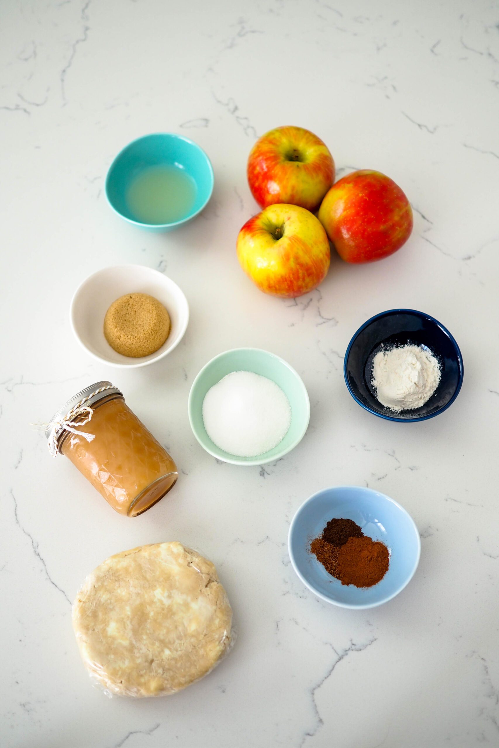 Ingredients used in making mini caramel apple pies.
