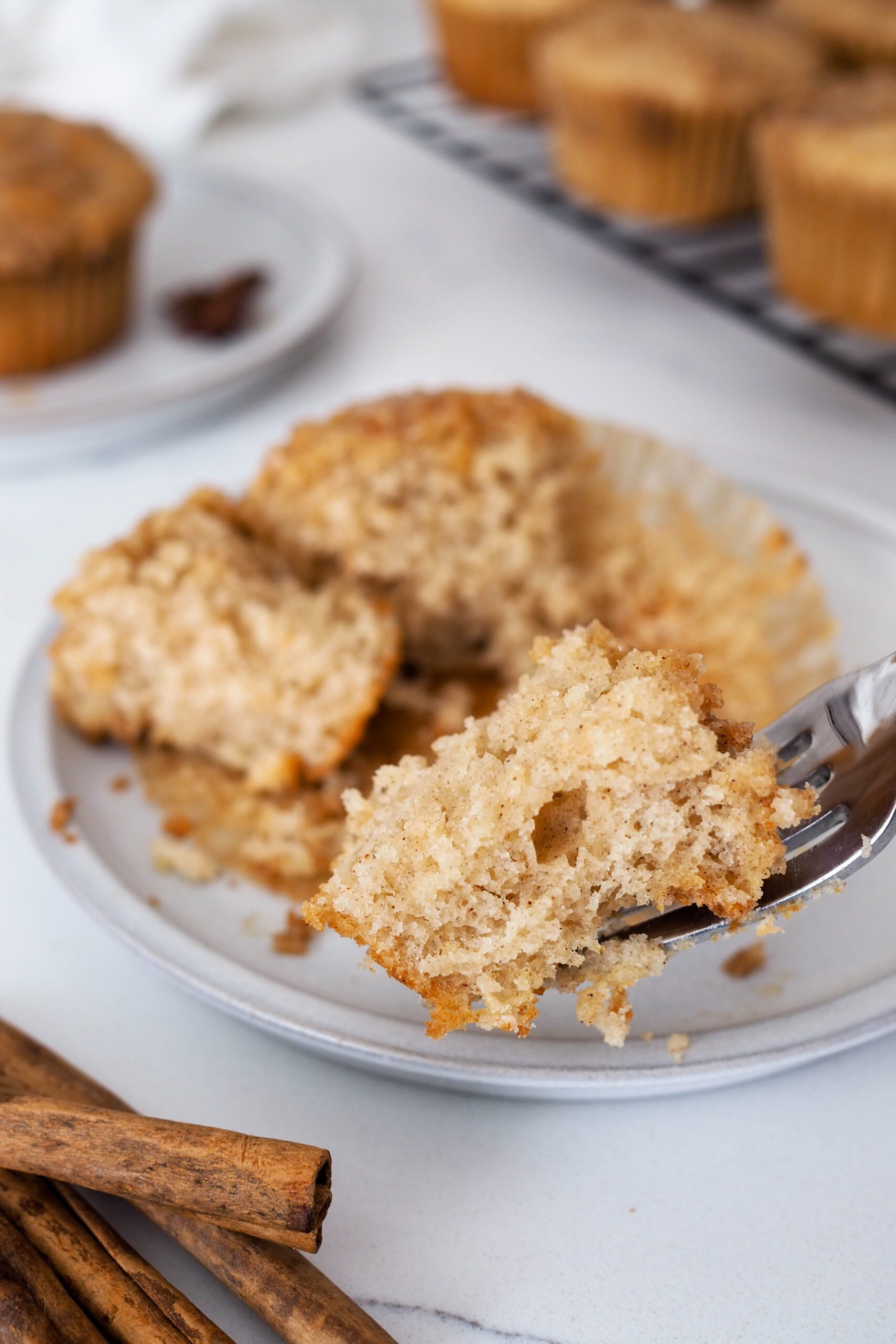 A bite of caramel chai muffin held up close to the camera with a fork.