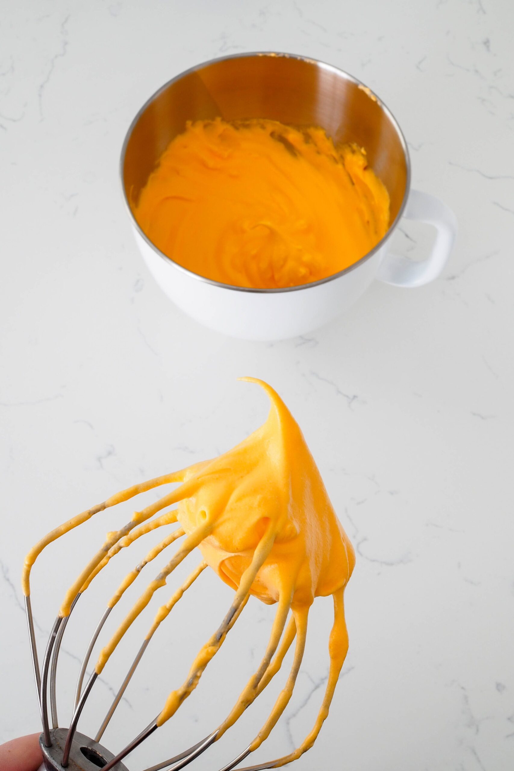 A clump of orange meringue with a stiff peak.