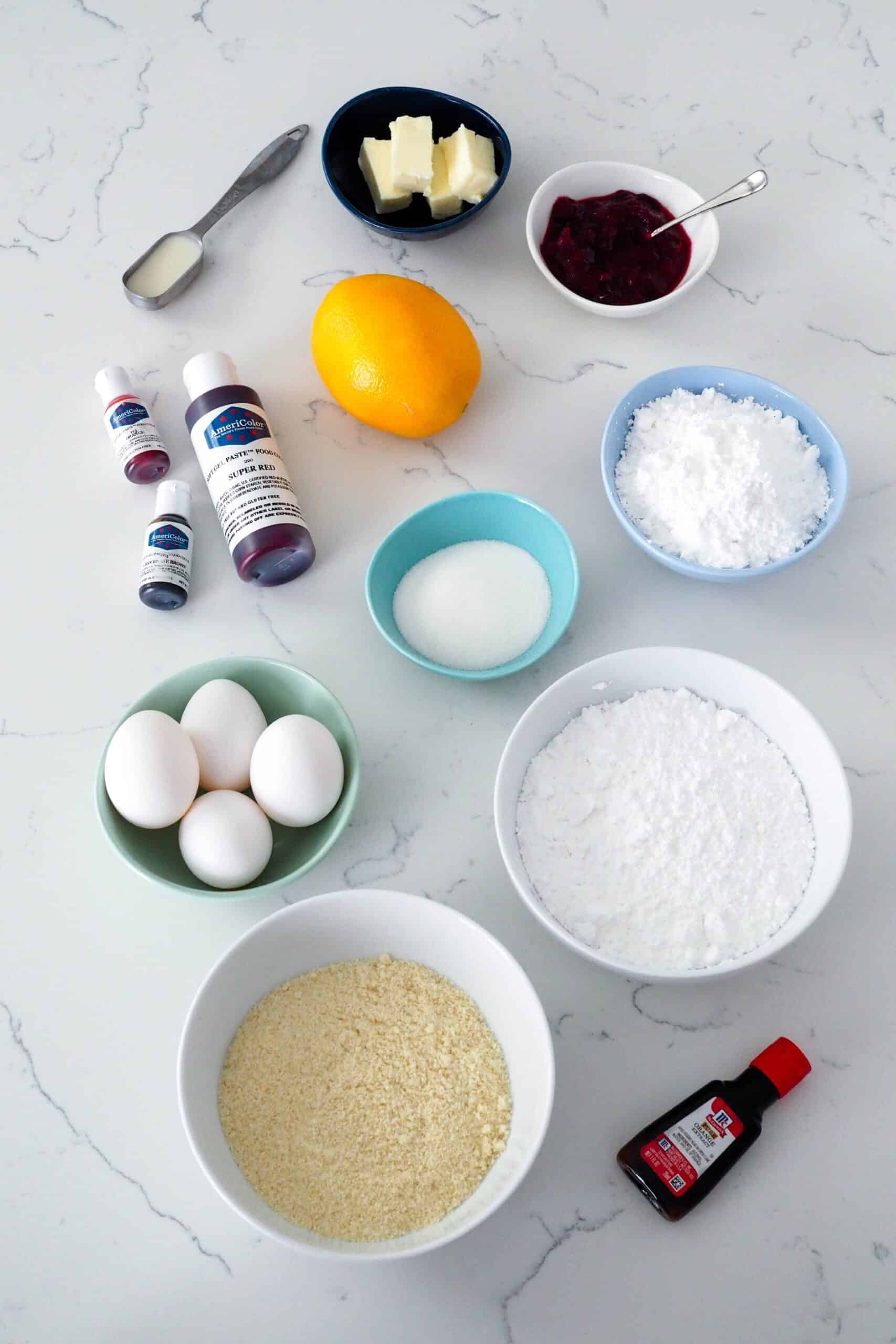 Ingredients for cranberry orange macarons arranged on a white quartz counter.