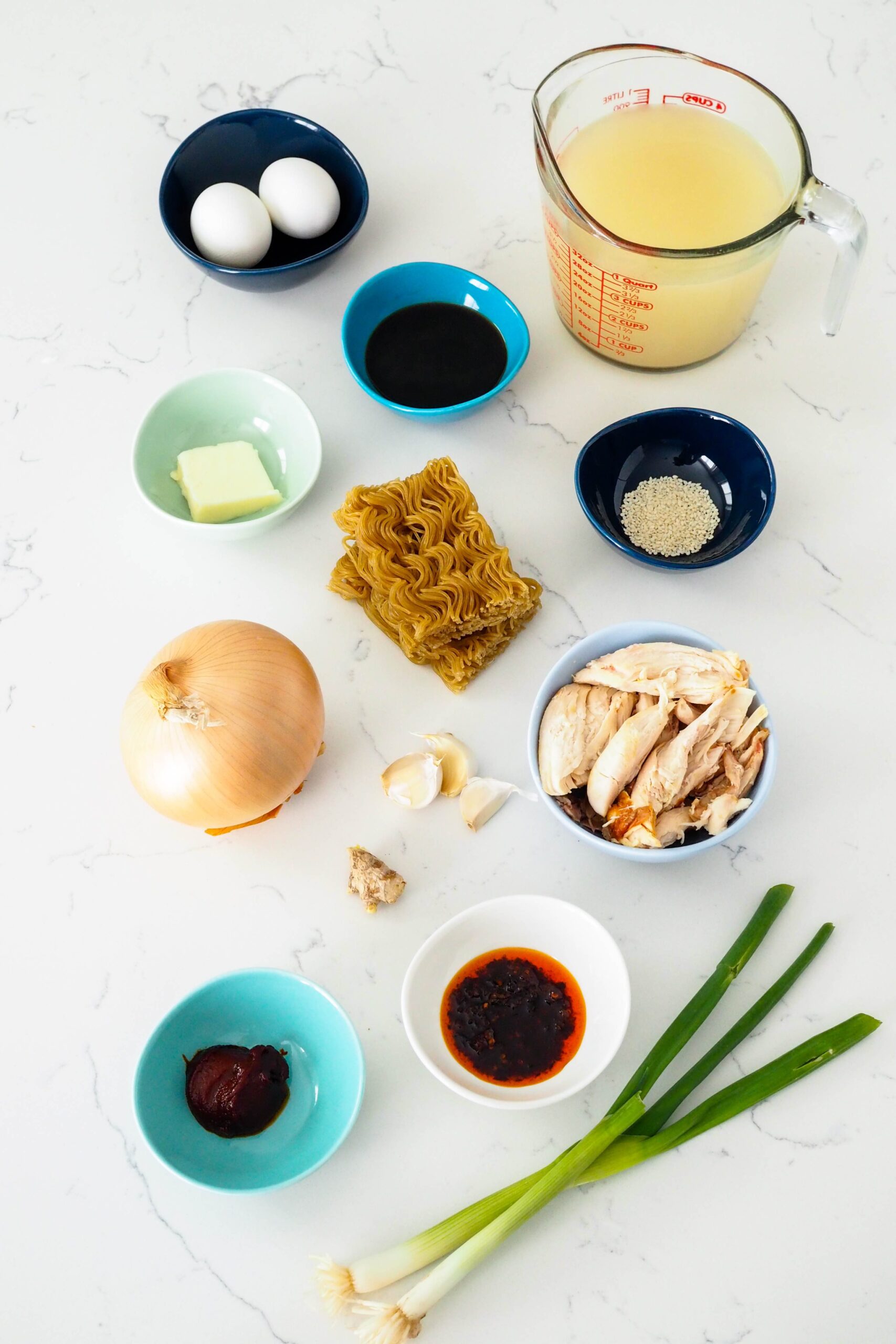 Ingredients for easy gochujang chicken ramen arranged on a counter.