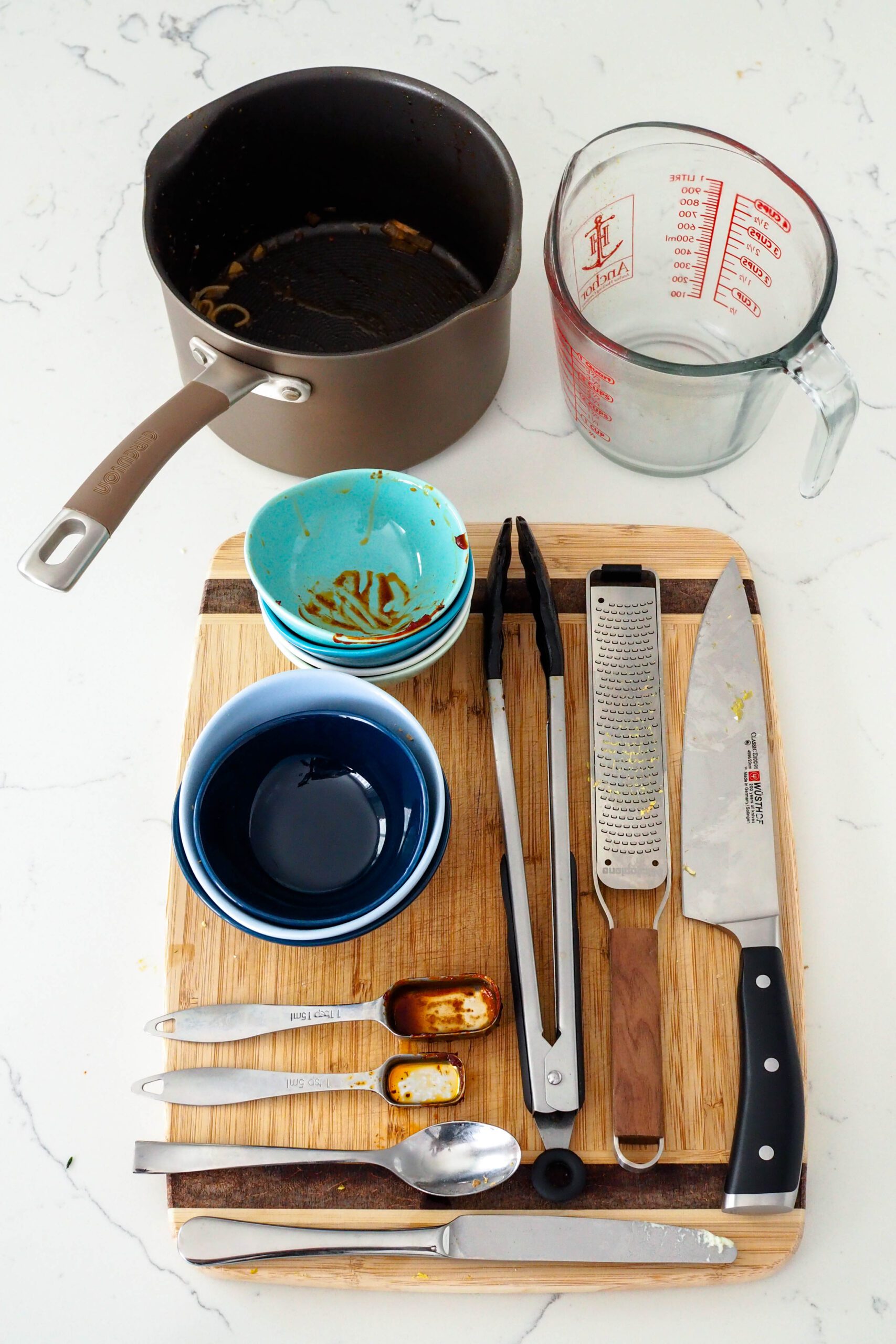 Dishes and utensils used to make the gochujang chicken ramen.