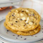A stack of lavender chocolate chip cookies on a plate.