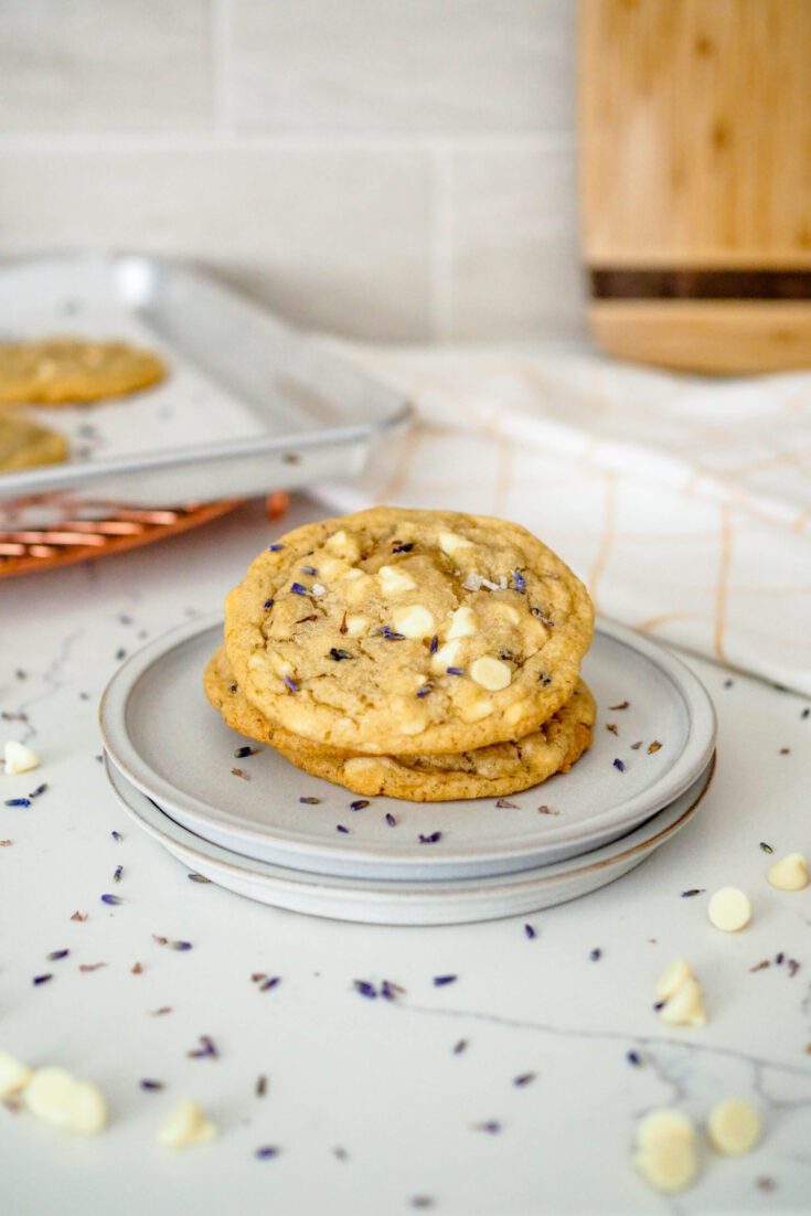 A stack of lavender chocolate chip cookies on a plate.