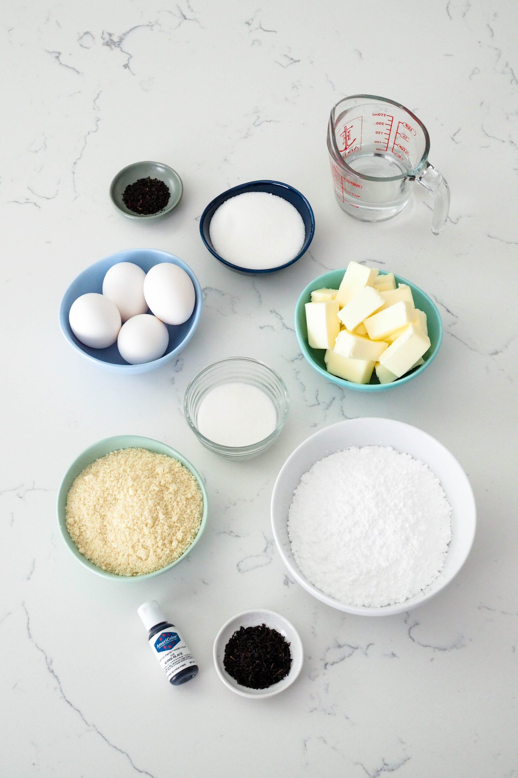 Ingredients for Earl Grey macarons on a quartz counter.