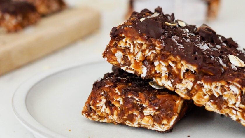 Chocolate protein granola bars arranged on a grey plate.