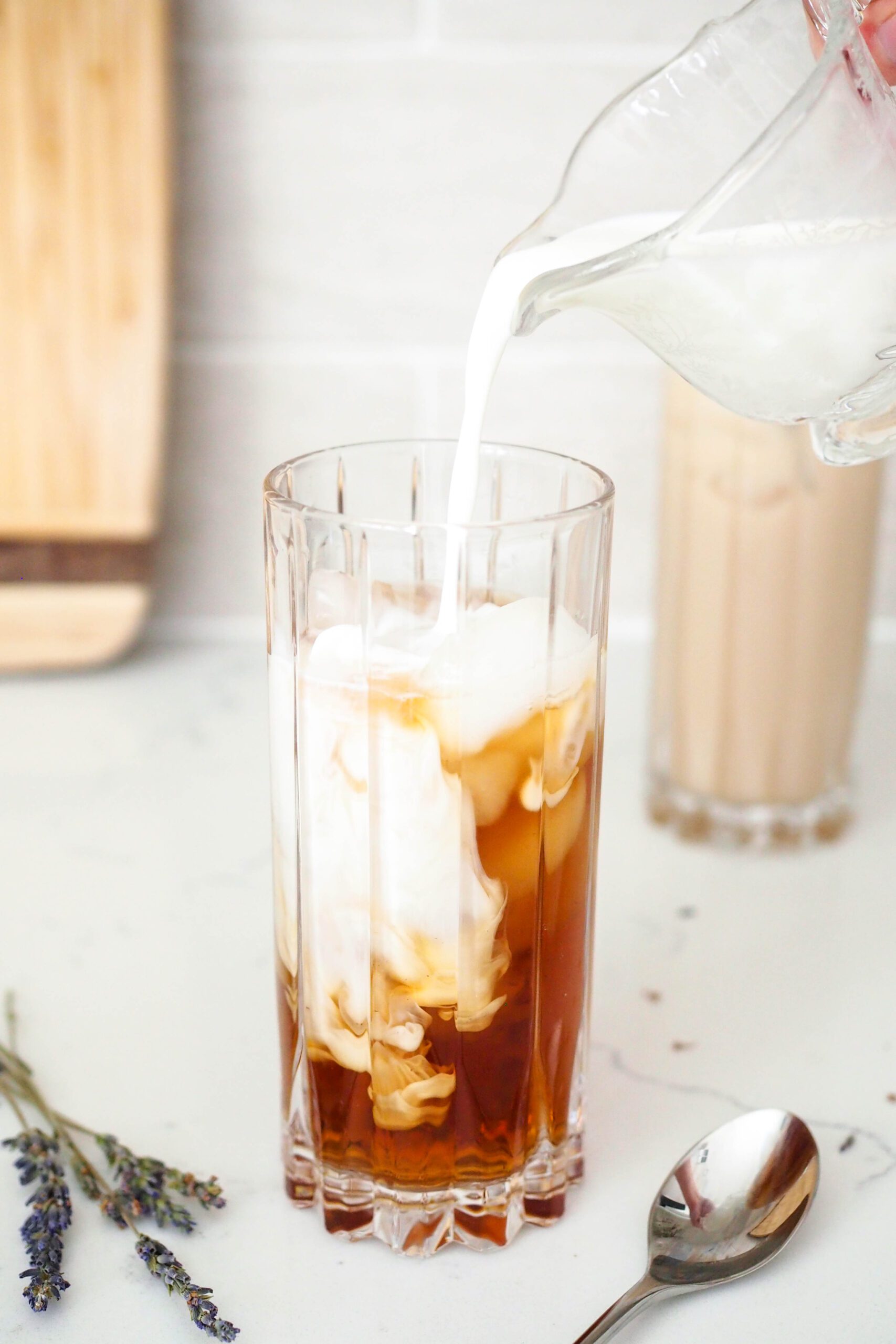 Milk is poured into iced tea.