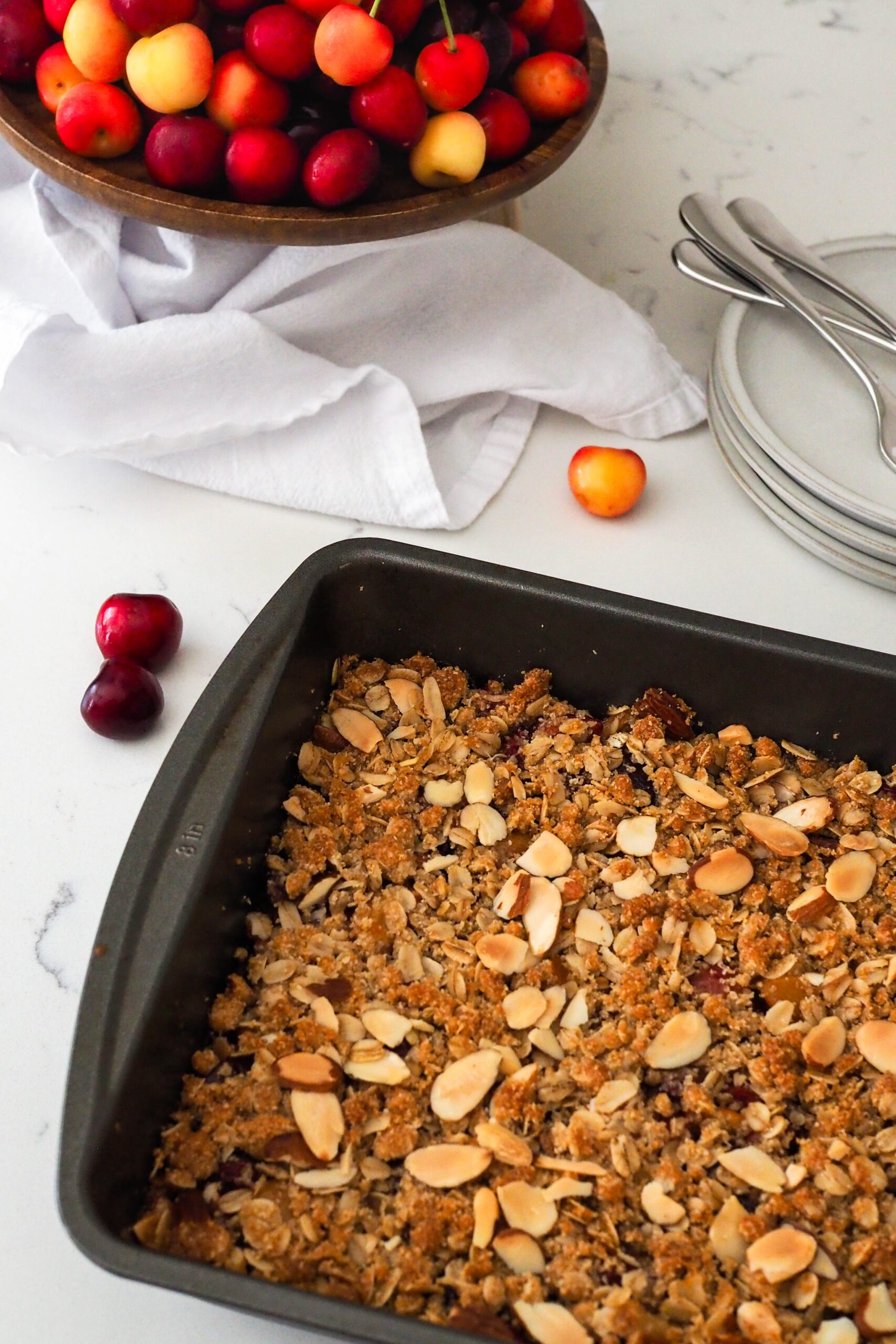 Baked gluten-free cherry almond crumble in a pan fresh out of the oven.