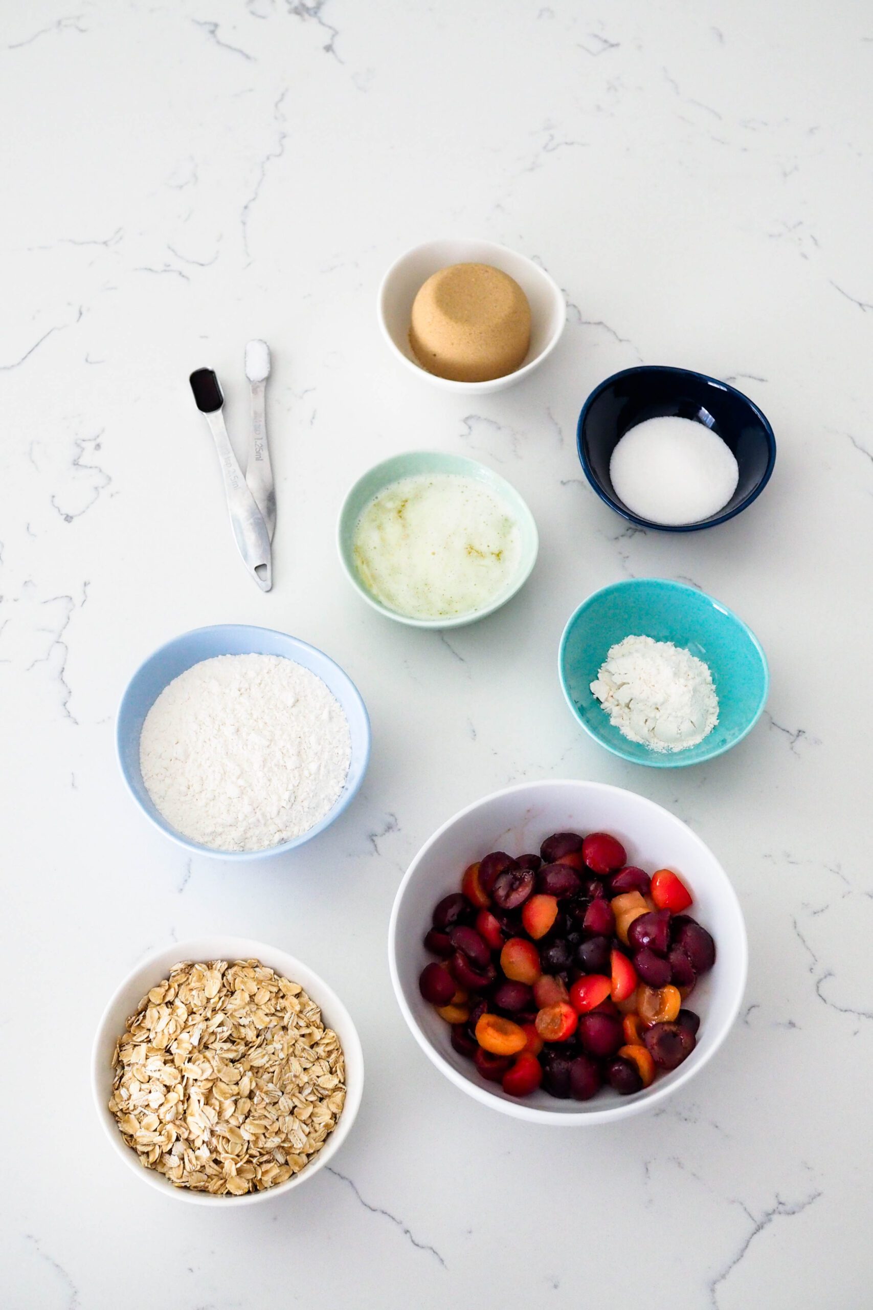 Ingredients for cherry crumble bars laid out on a counter.