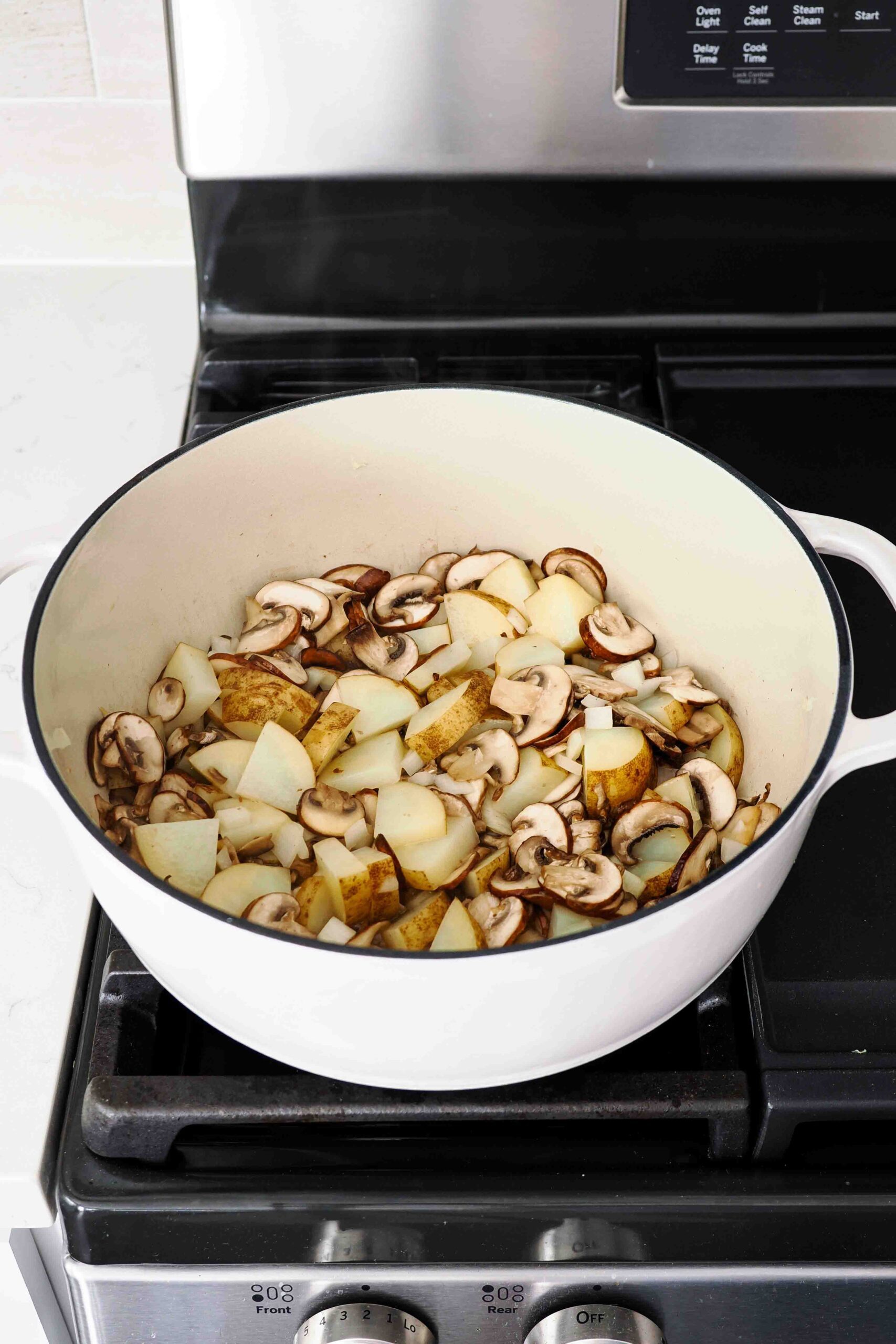 Cooked down mushrooms and potatoes in a Dutch oven.