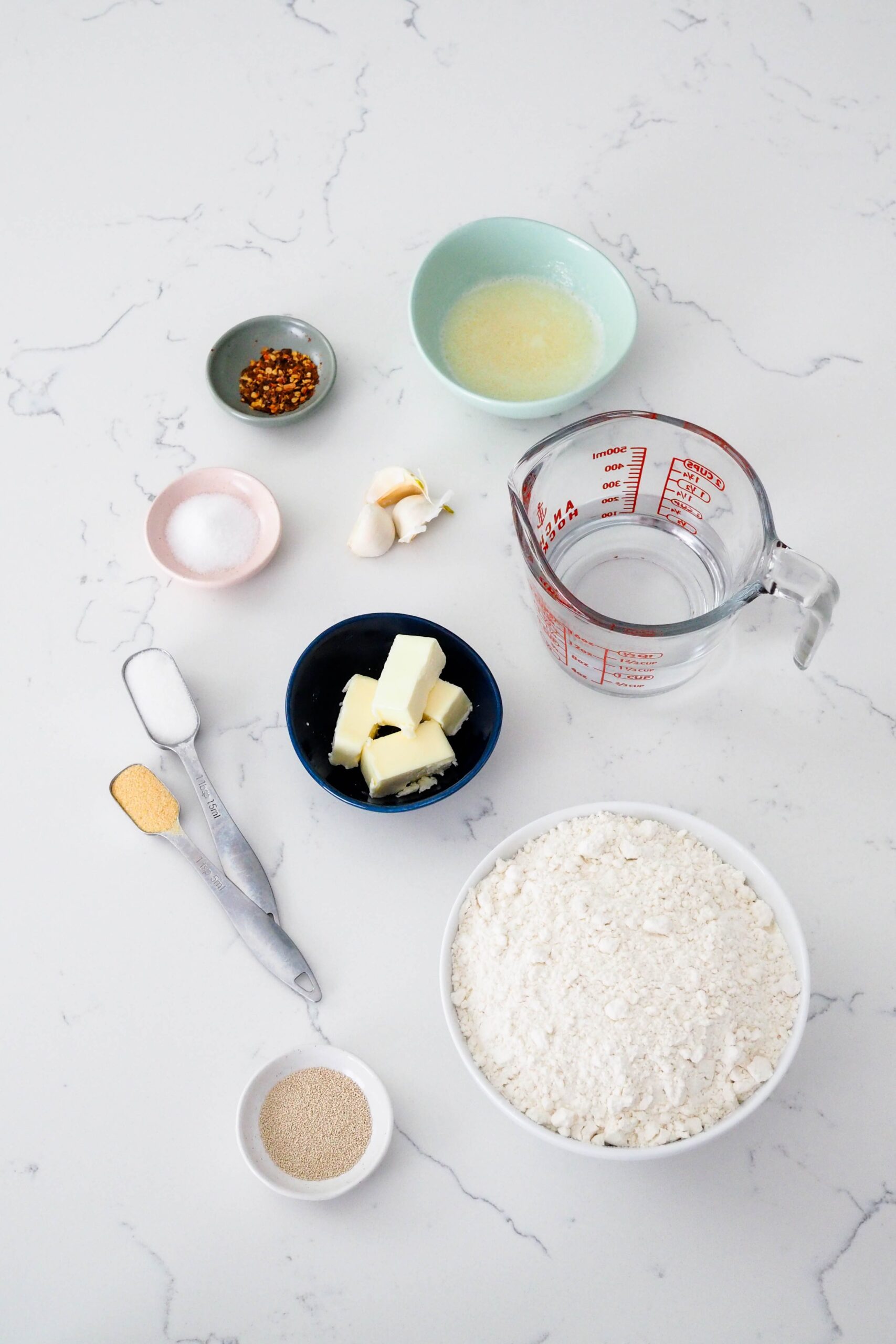 Ingredients for garlic breadsticks on a counter.