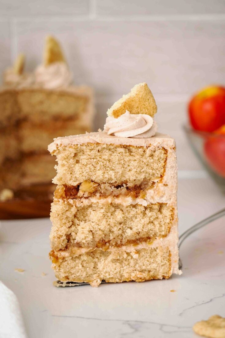 A large slice of apple snickerdoodle cake on a cake server.