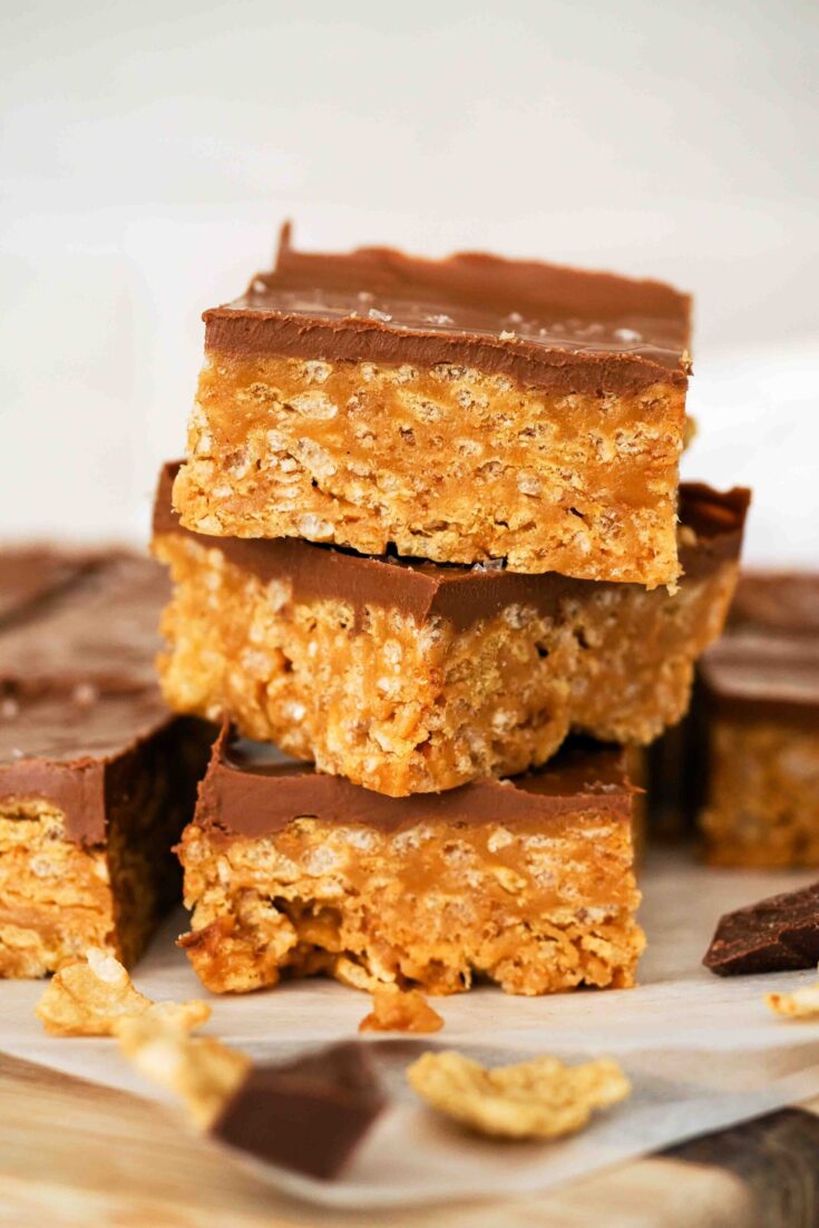 A stack of three Special K Bars on parchment paper.