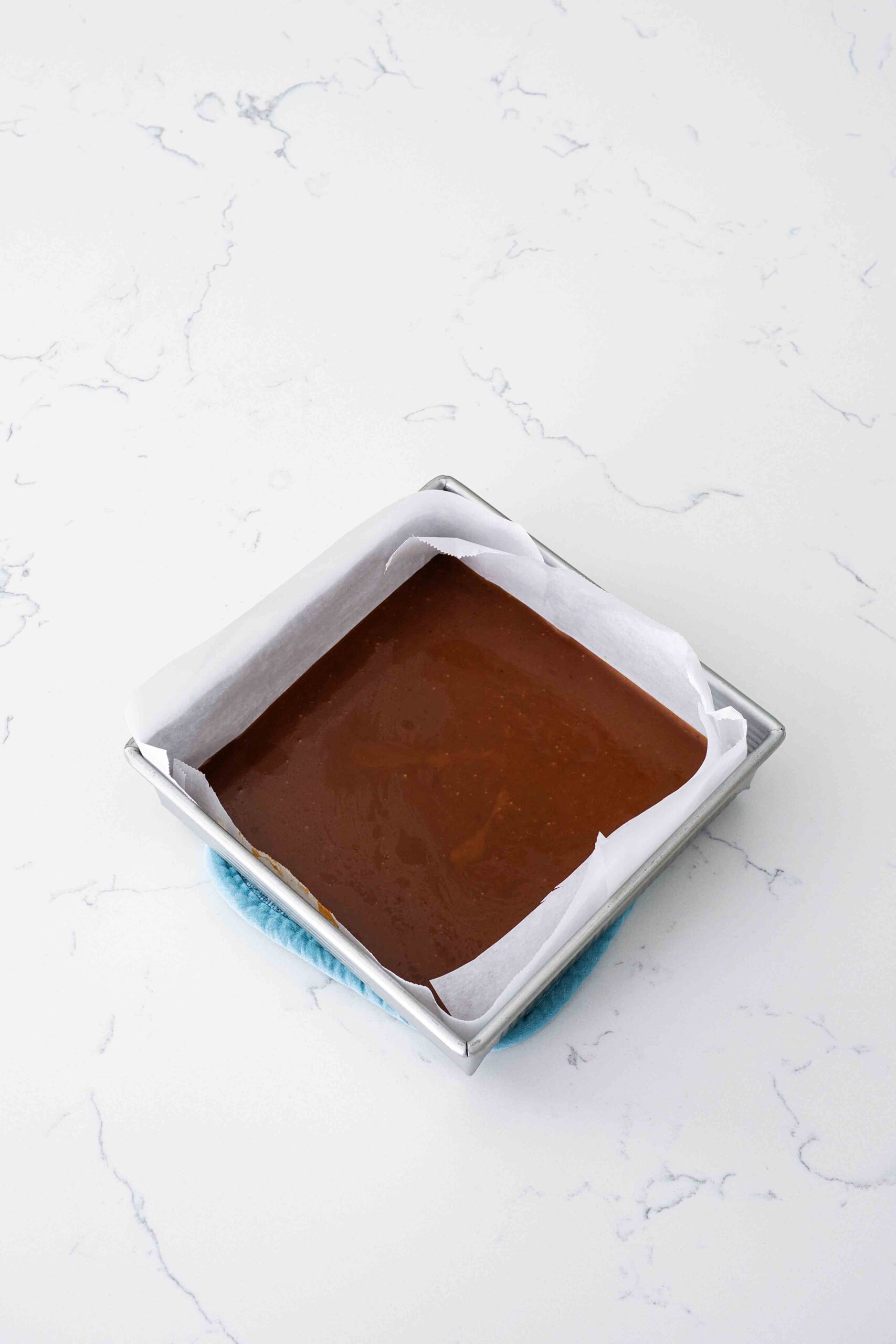 Pumpkin spice caramel sets in a square pan.