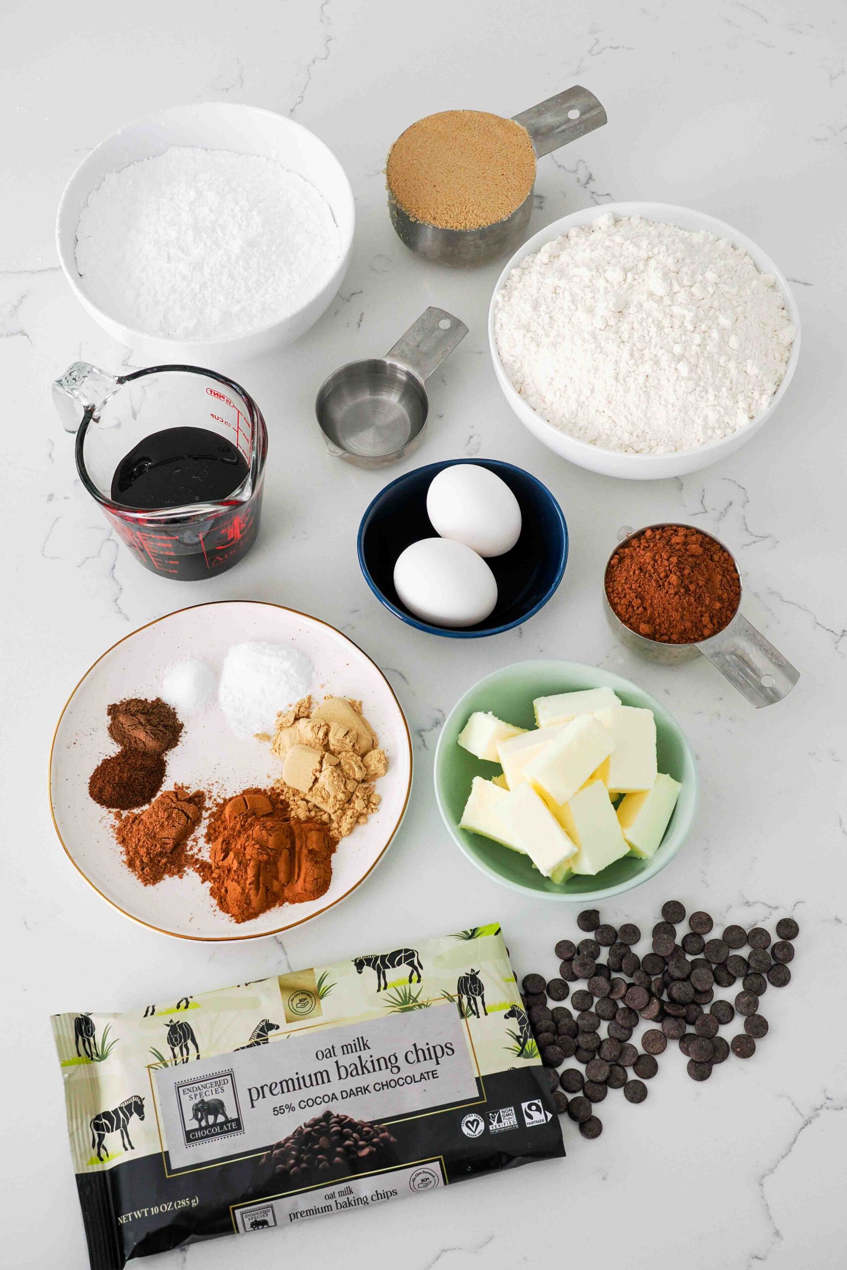 A collection of ingredients used to make chocolate gingerbread cookies.