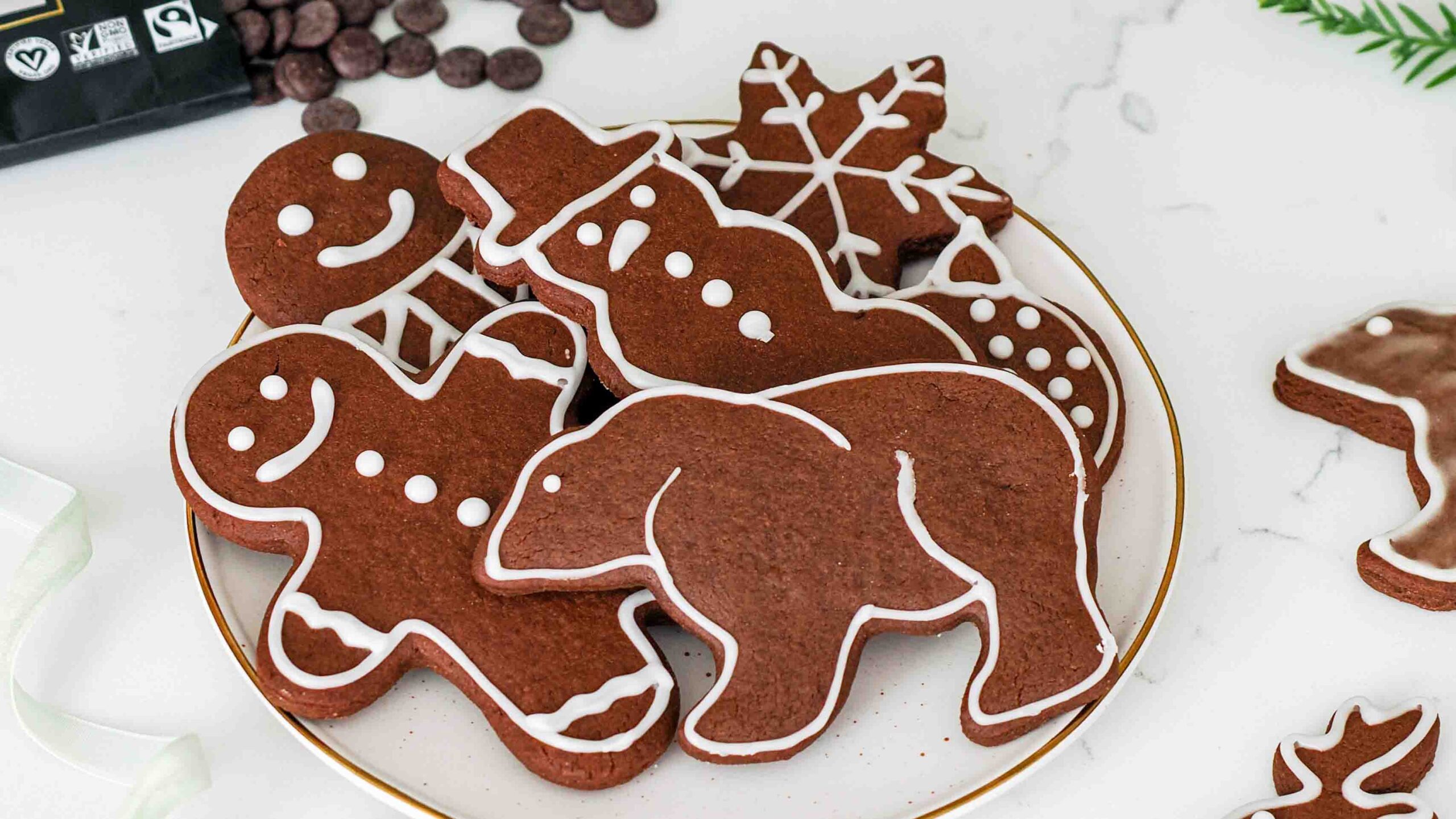 A pile of chocolate gingerbread cookies on a plate.