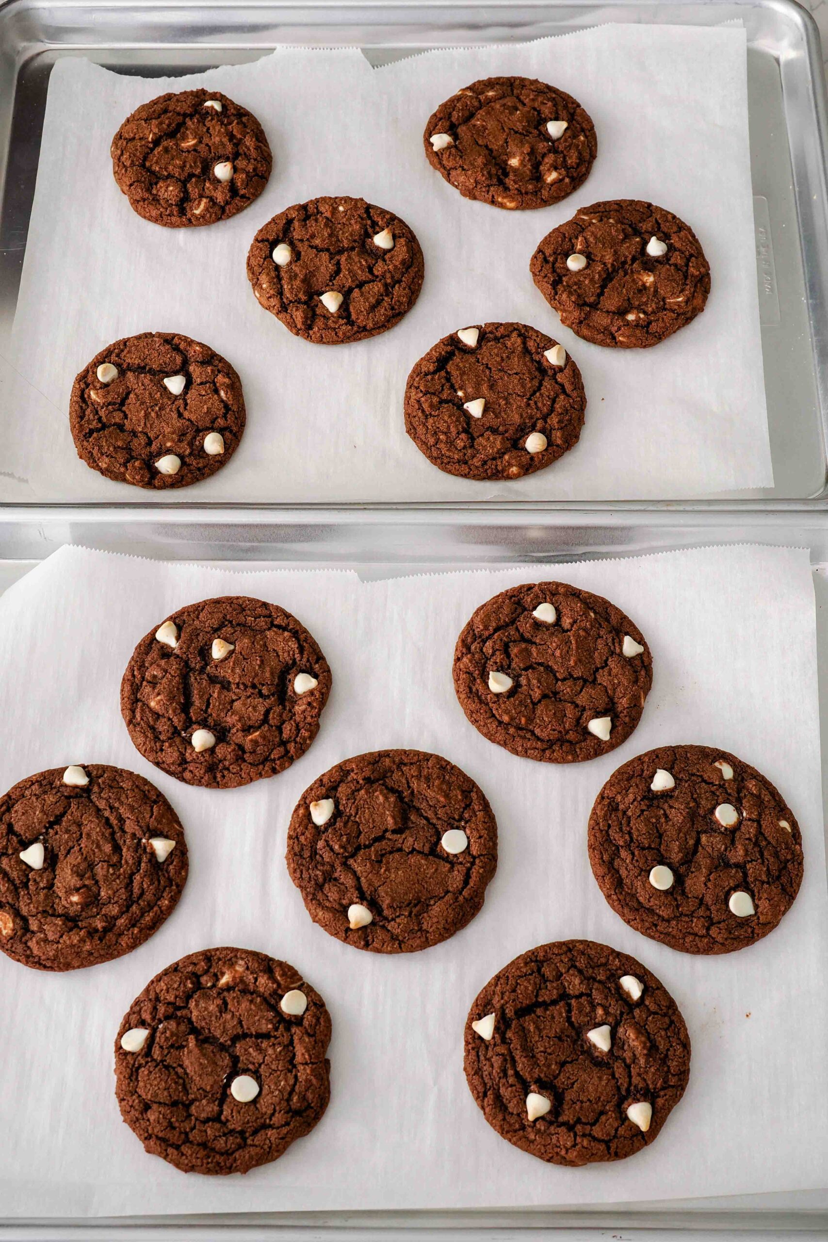 Baked chocolate peppermint cookies on parchment-lined baking sheets.