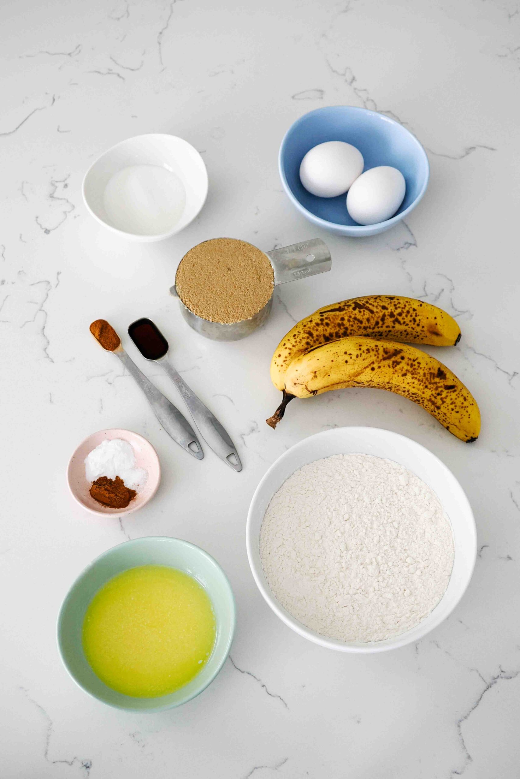Ingredients for banana bread on a quartz counter.