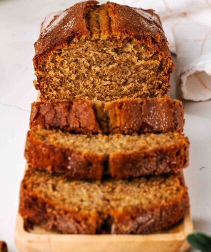 A sliced loaf of cinnamon banana bread with a crackly cinnamon sugar crust.