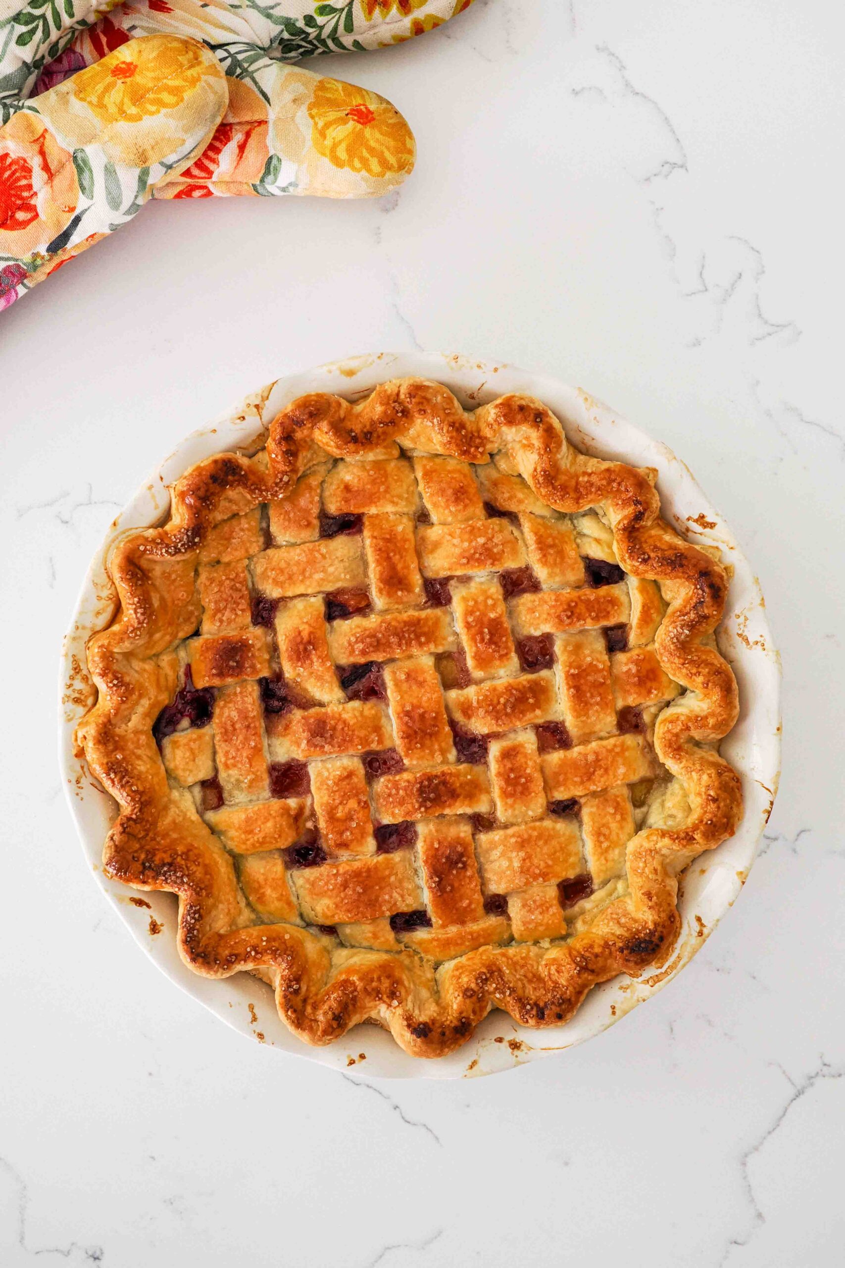 A fully baked and golden brown cherry lattice pie with almond extract.