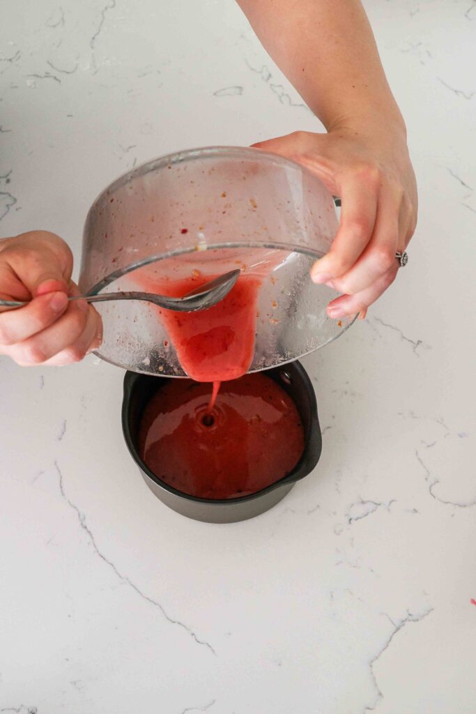 Leftover red cherry juice is poured into a saucepan.
