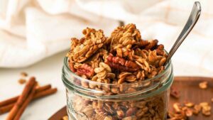 Maple pecan granola in a glass jar.