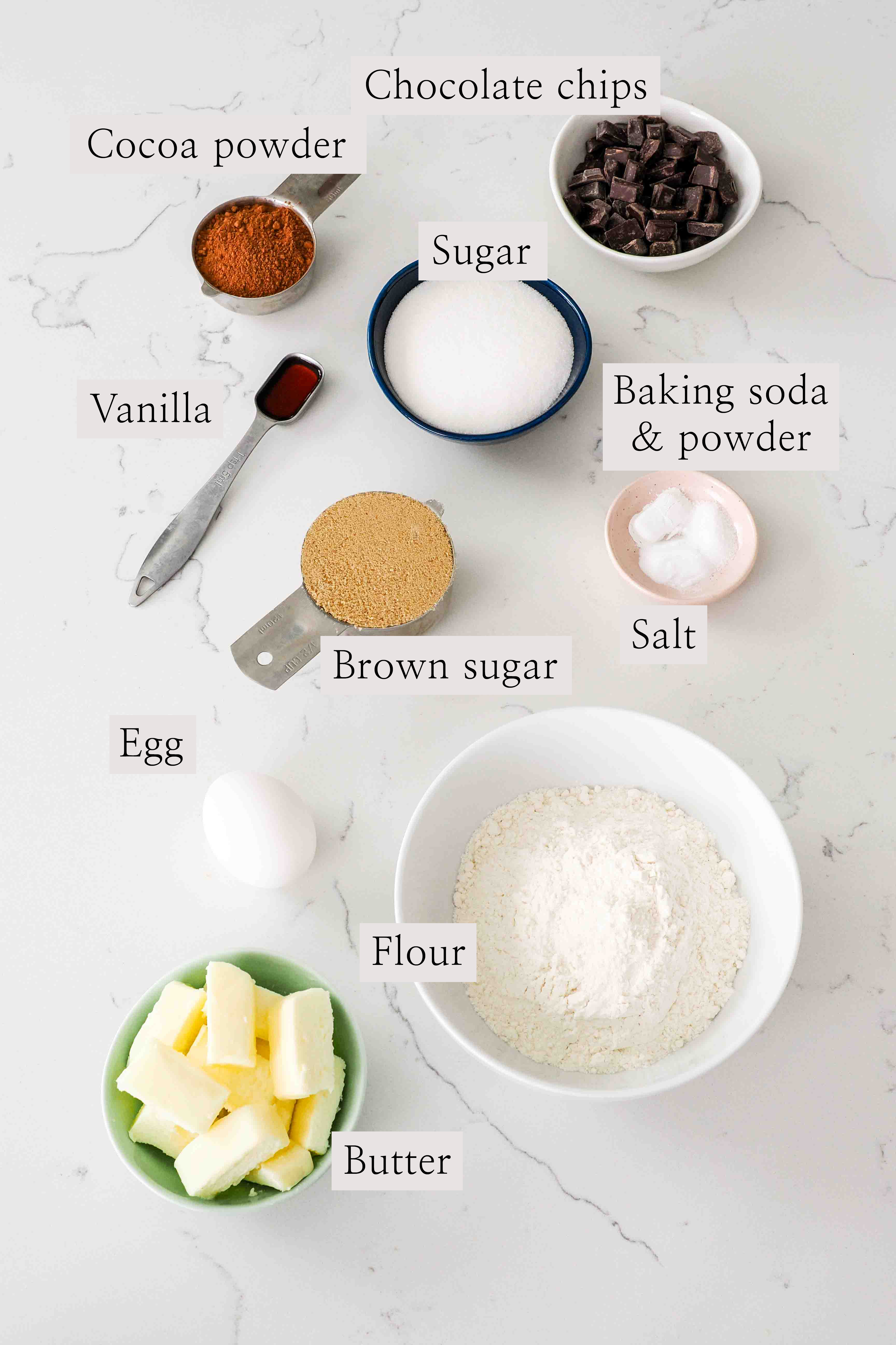 Ingredients for double chocolate chip cookies laid out on a counter.