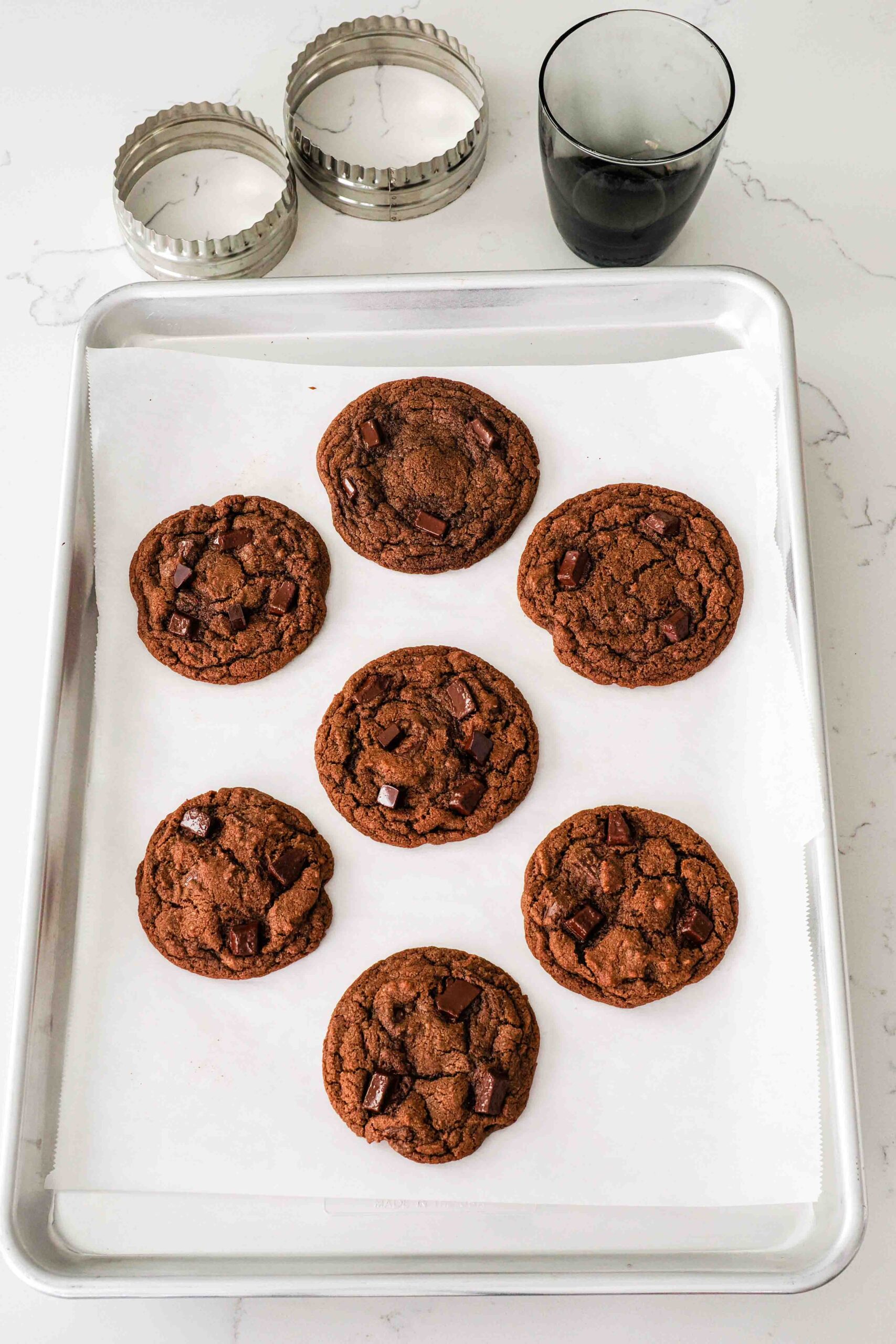 Double chocolate chip cookies after being swirled with a circle cutter.