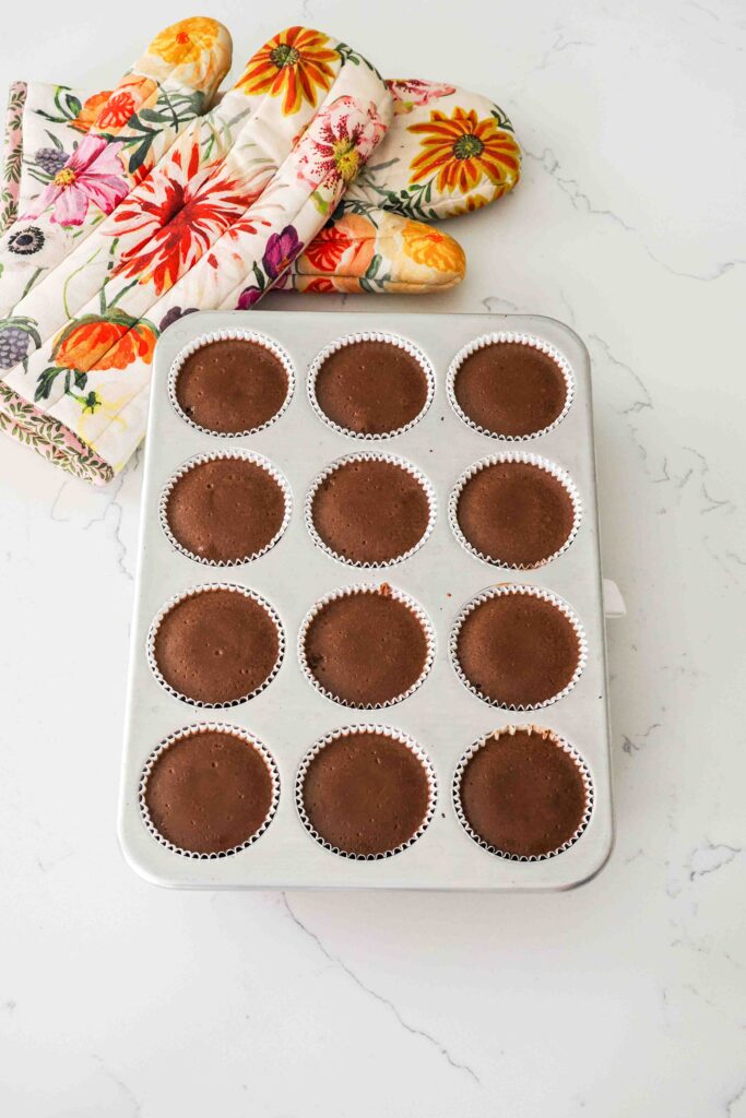 Baked mini chocolate cheesecakes fresh from the oven.
