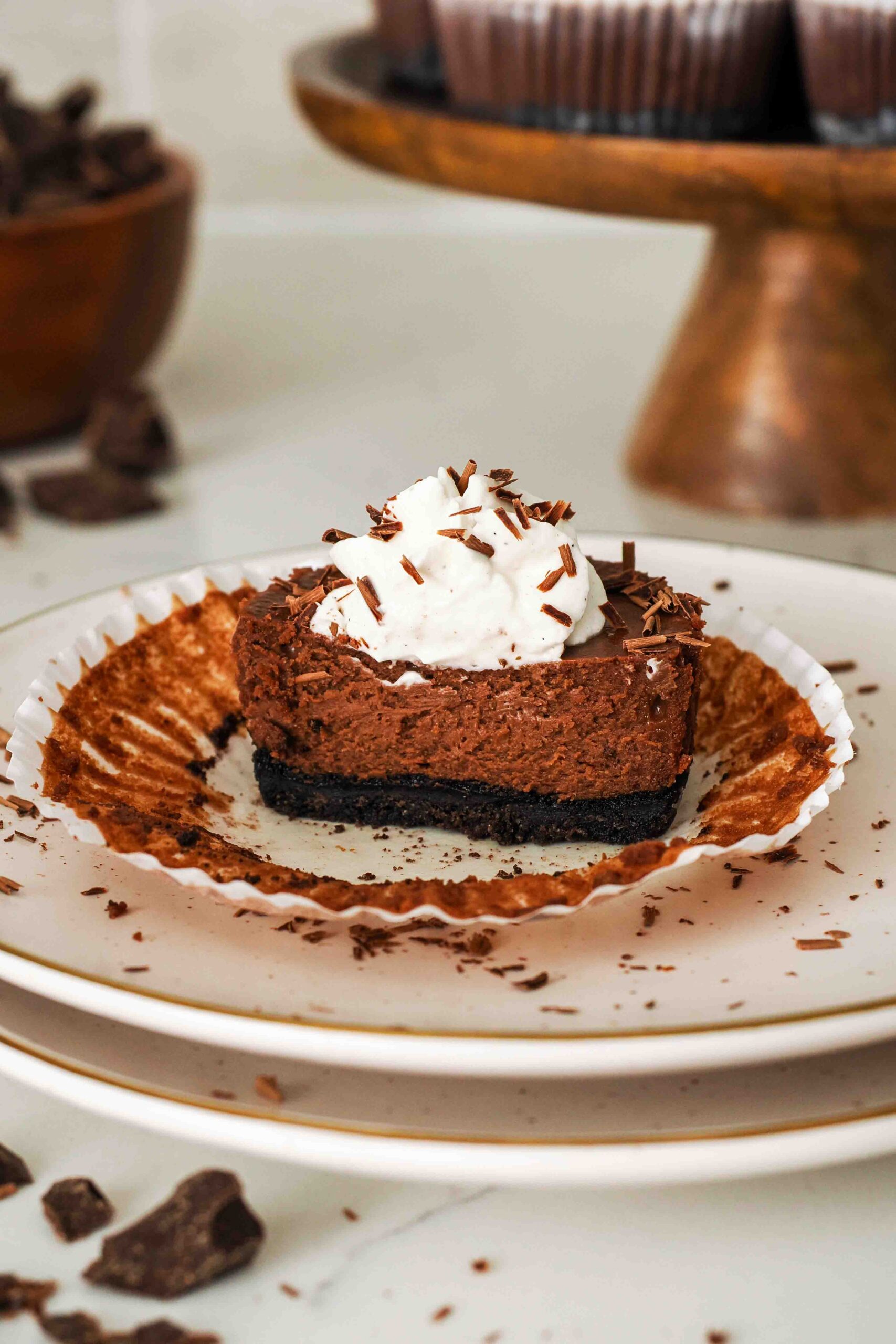 Half of a mini chocolate cheesecake on a plate.