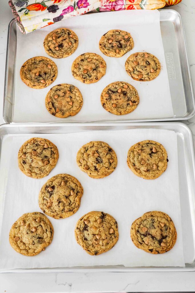Baked caramel chocolate chip cookies on a baking sheet.