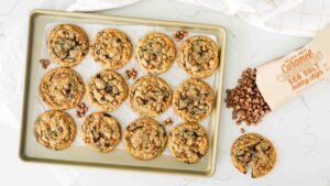 Overhead image of caramel chocolate chip cookies on a baking sheet.