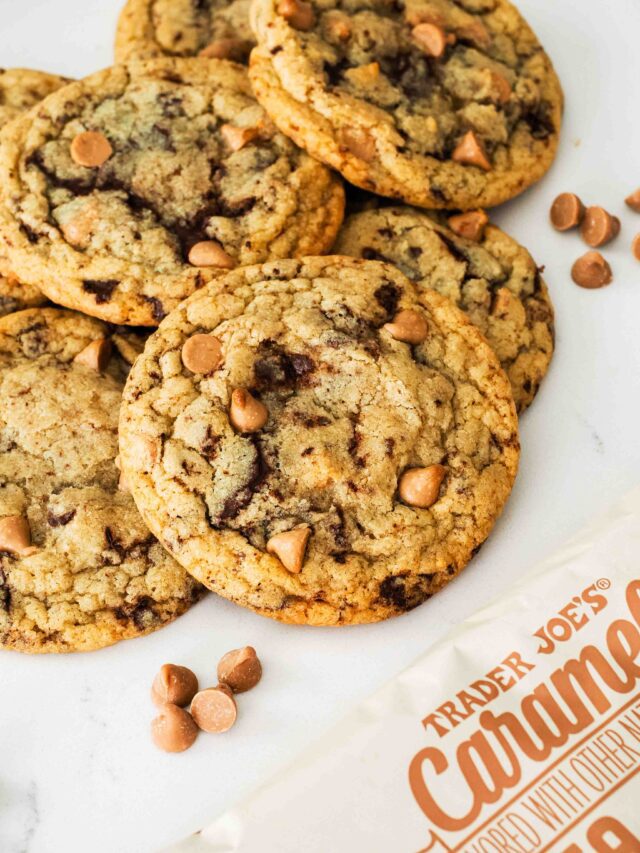 A caramel chocolate chip cookie with a bag of caramel chips in the corner.