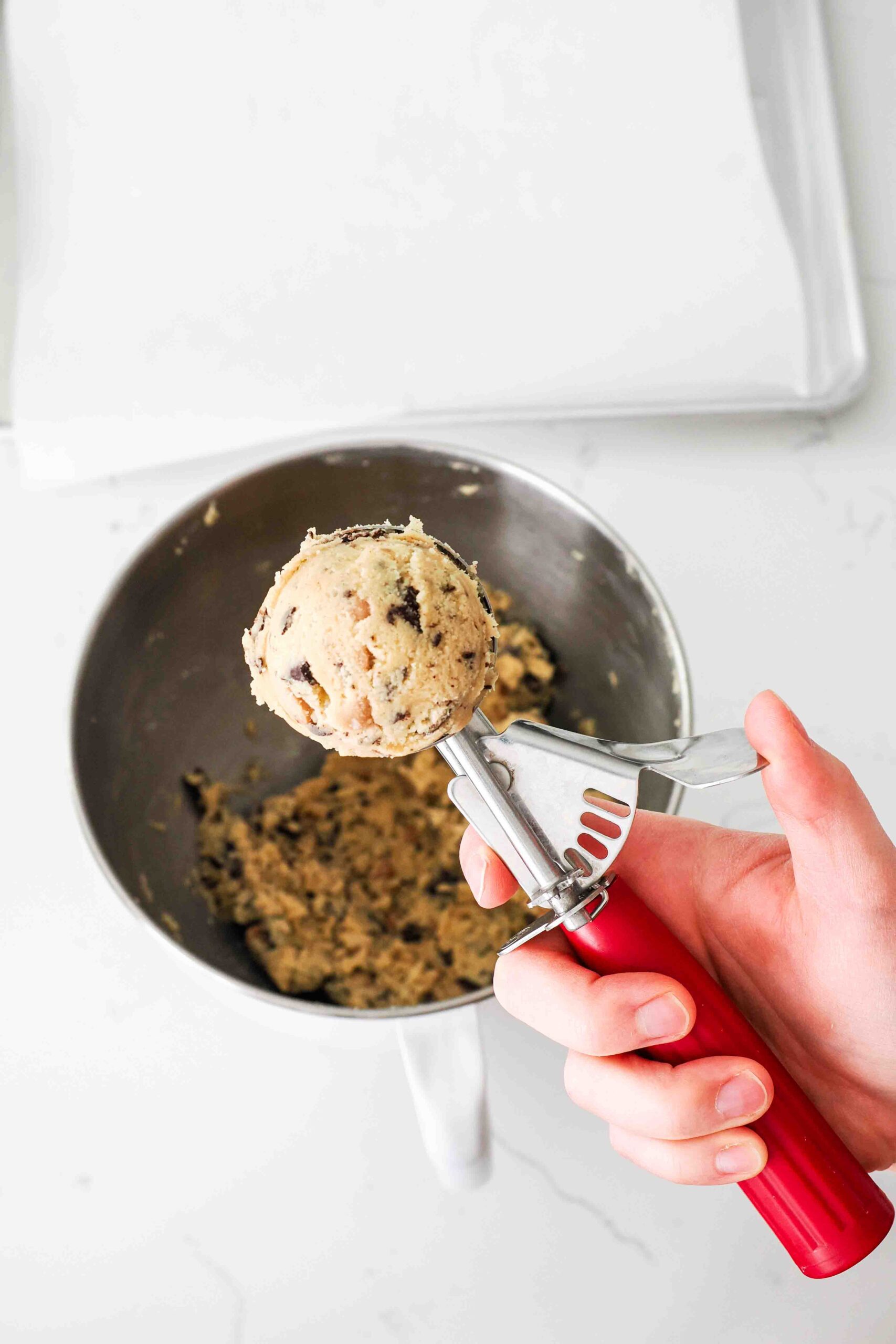 A closeup of a scoop of caramel chocolate chip cookie dough.
