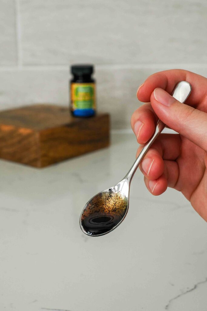 A small spoon with vanilla bean paste.