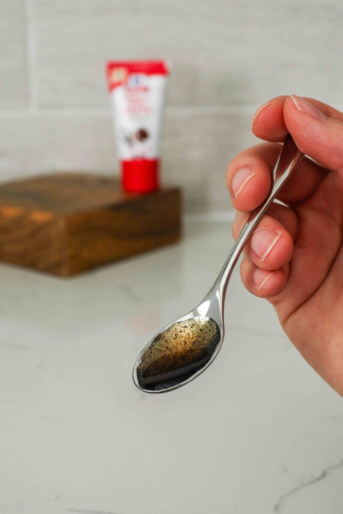 A small spoon with vanilla bean paste.