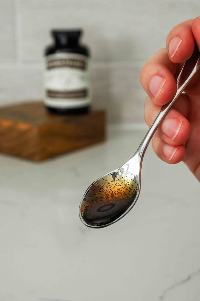 A small spoon with vanilla bean paste.