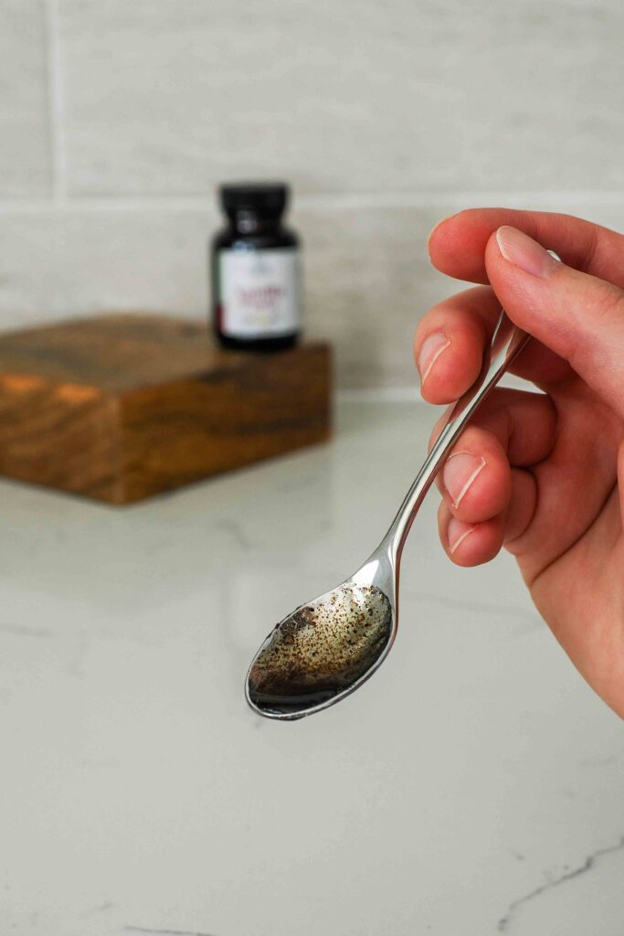 A small spoon with vanilla bean paste.
