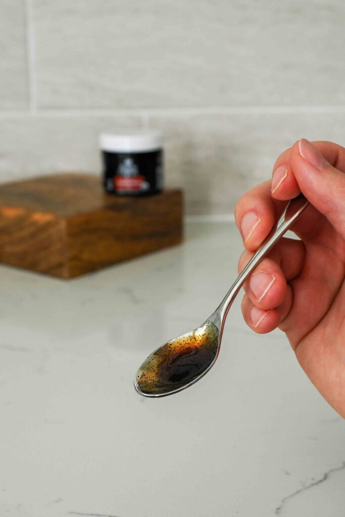 A small spoon with vanilla bean paste.