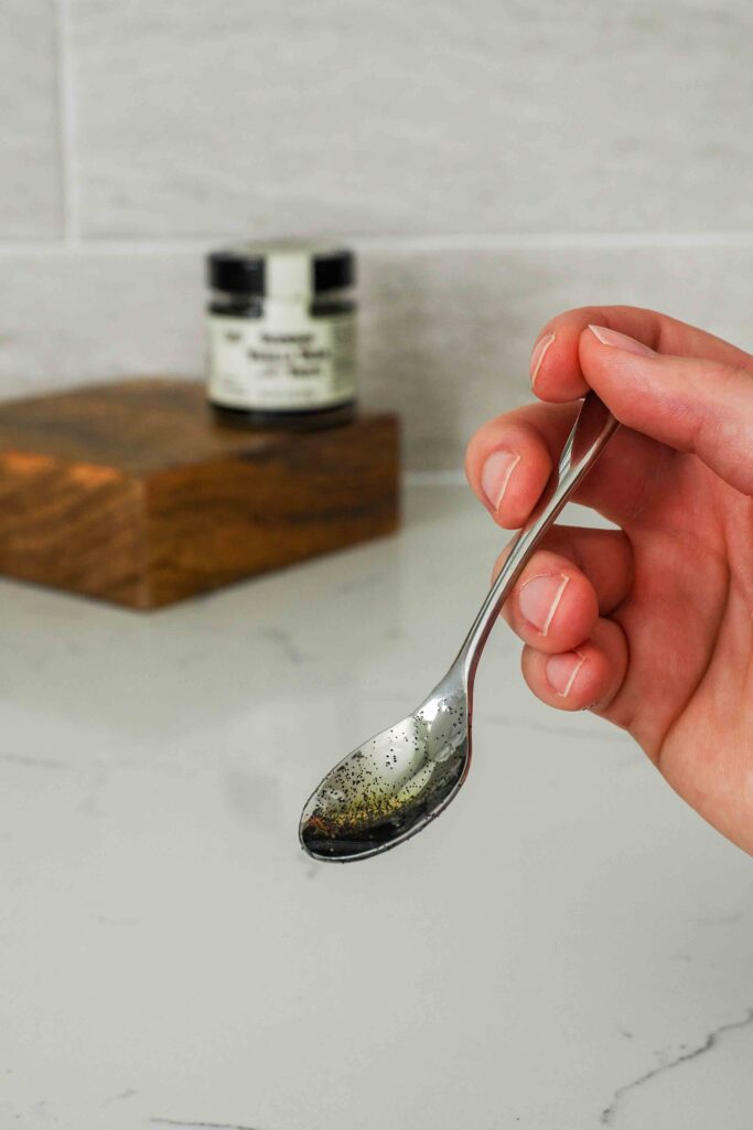 A small spoon with vanilla bean paste.