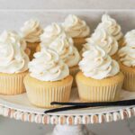 Vanilla bean cupcakes on a cake stand.