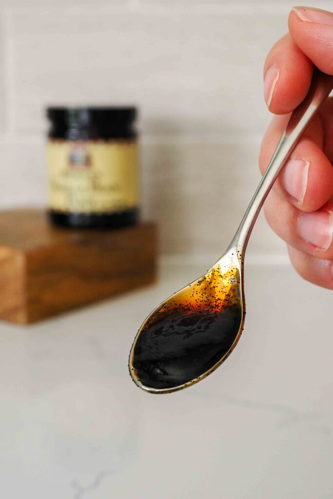 A small spoon with vanilla bean paste.