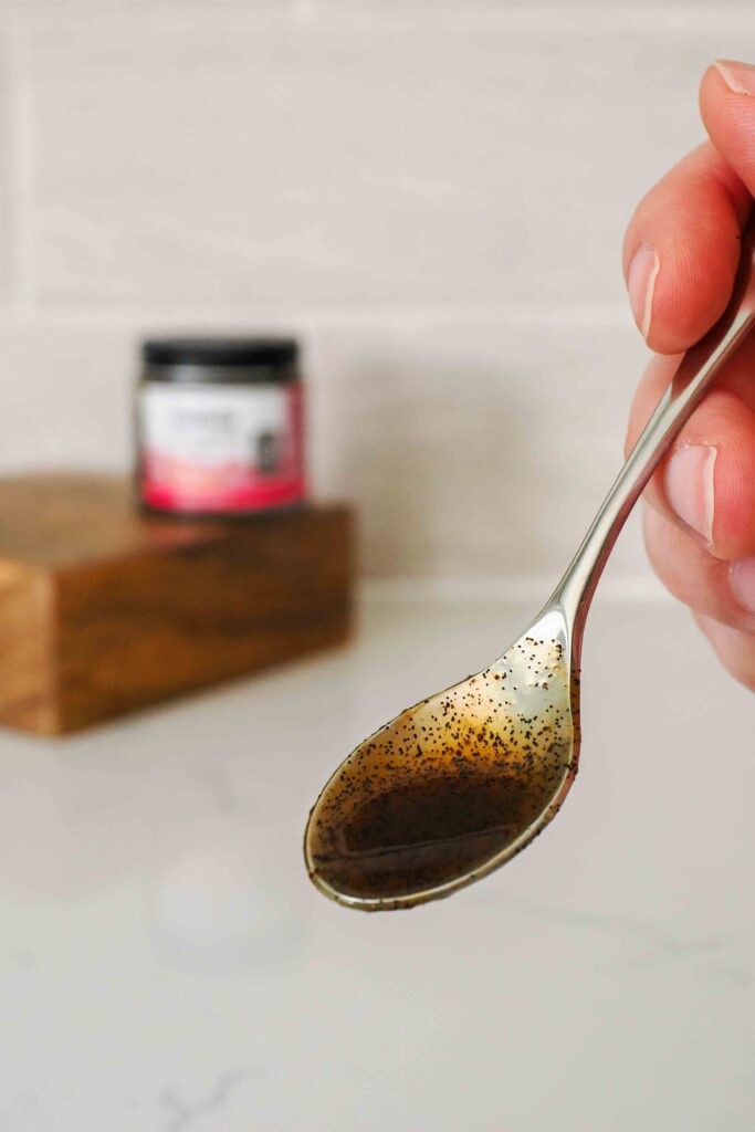 A small spoon with vanilla bean paste.